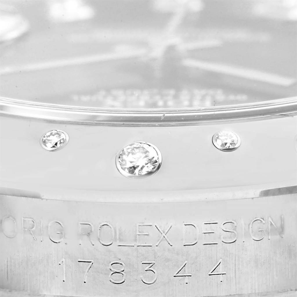 The image shows a close-up view of the bezel and part of the case of a Mid-Size Rolex watch, with diamonds and the model number 178344 engraved.