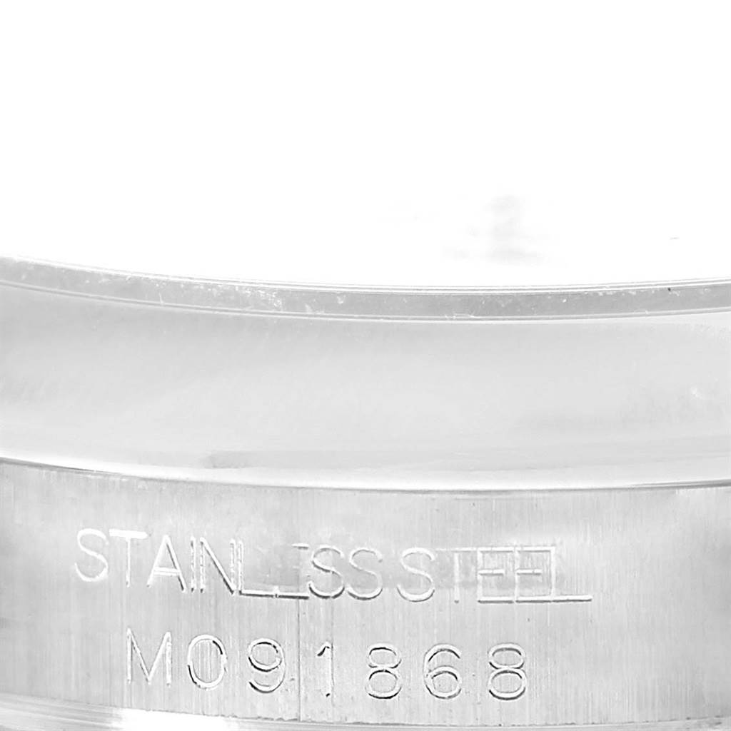 This close-up image shows the serial number and "STAINLESS STEEL" engraving on the case of a Rolex Mid-Size 177200 Women's Stainless Steel Silver Dial 177200 Women's Stainless Steel Silver Dial model.