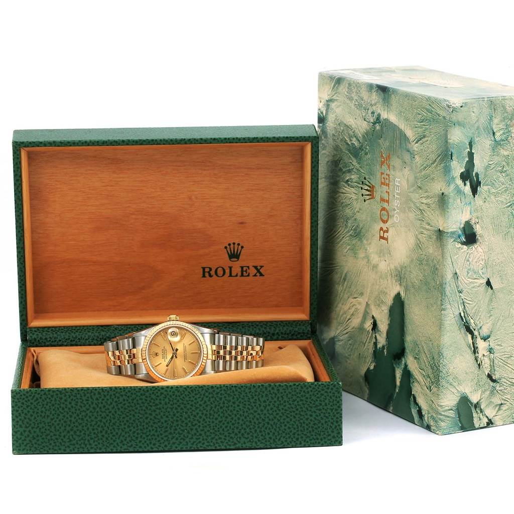 This image shows a Rolex Mid-Size 68273 Women's Steel and Gold (two tone) Champagne Dial 68273 Women's Steel and Gold (two tone) Champagne Dial watch in a display case, with the outer box beside it.