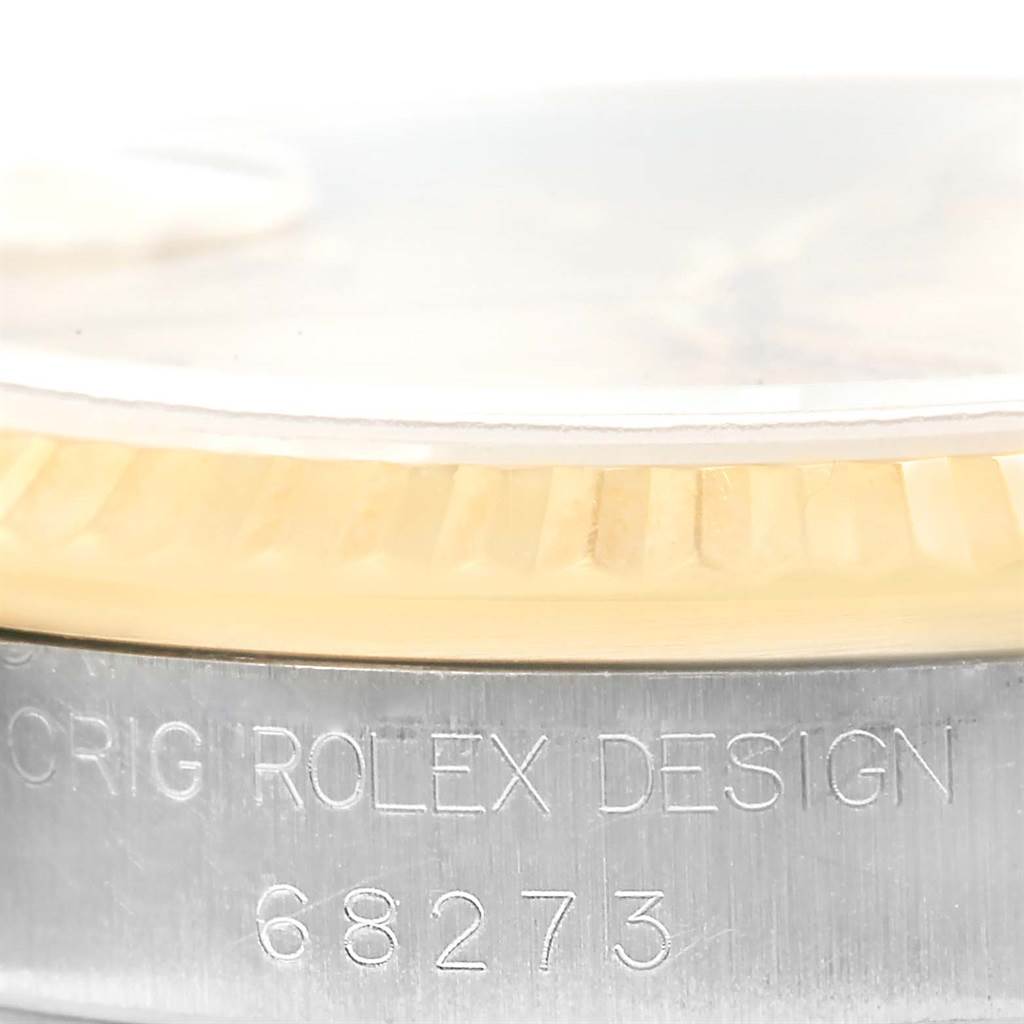 This close-up angle shows the side of a Mid-Size Rolex watch, displaying the fluted bezel and case engravings.