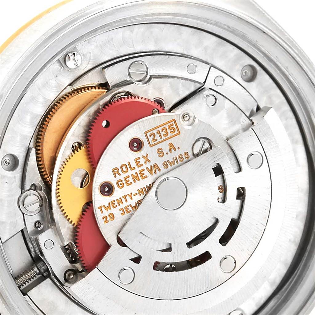 This image shows a close-up of the movement mechanism inside a mid-size Rolex watch, emphasizing the gears and inscriptions.