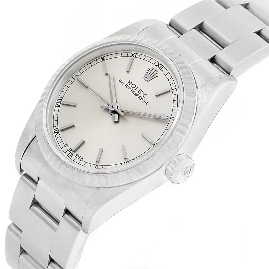 The image shows a Rolex Mid-Size 77014 Women's Stainless Steel Silver Dial 77014 Women's Stainless Steel Silver Dial Oyster Perpetual watch from an angled view, displaying its dial, bezel, and part of the bracelet.