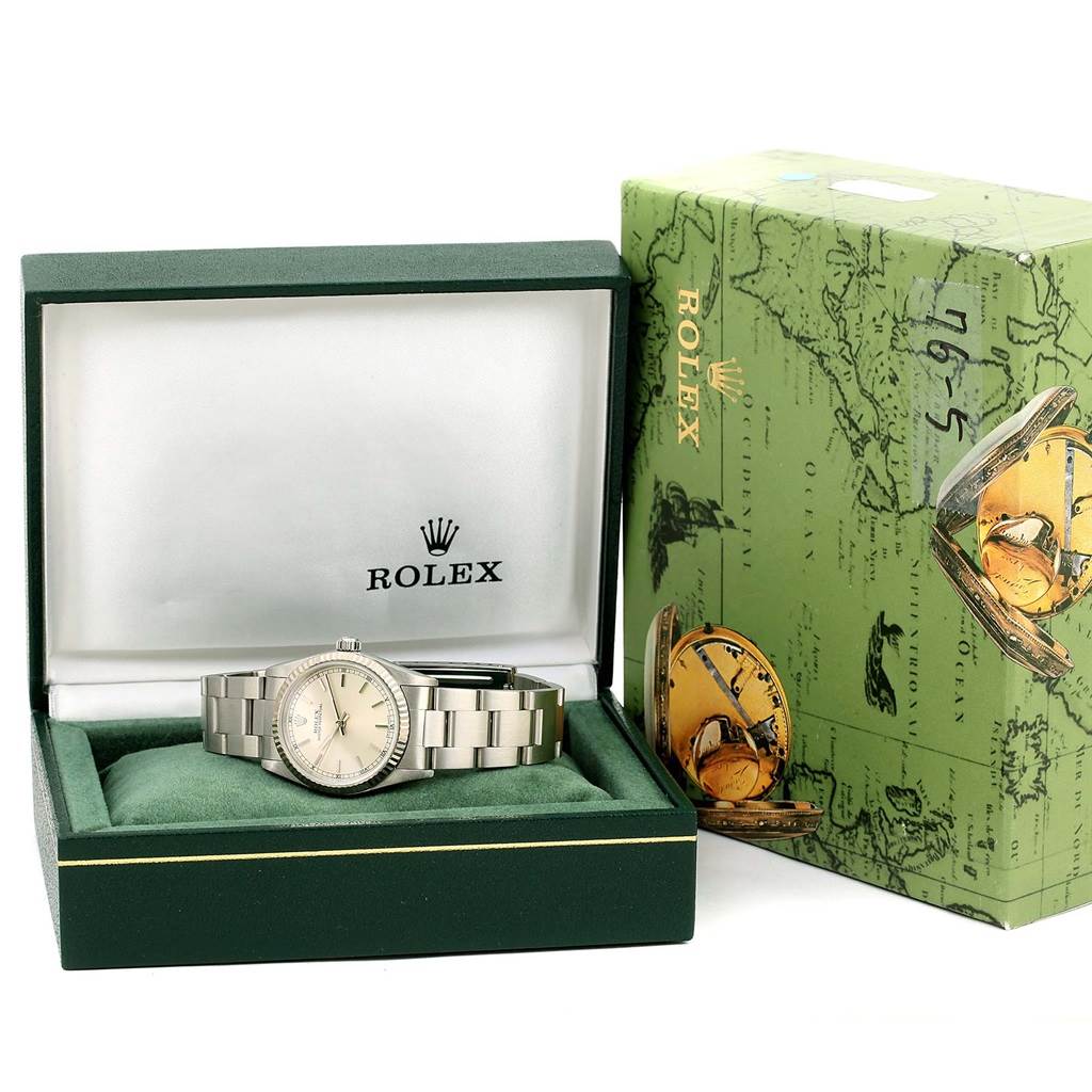 This image shows a Rolex Mid-Size 77014 Women's Stainless Steel Silver Dial 77014 Women's Stainless Steel Silver Dial watch in its open green box, with its branded outer box beside it.