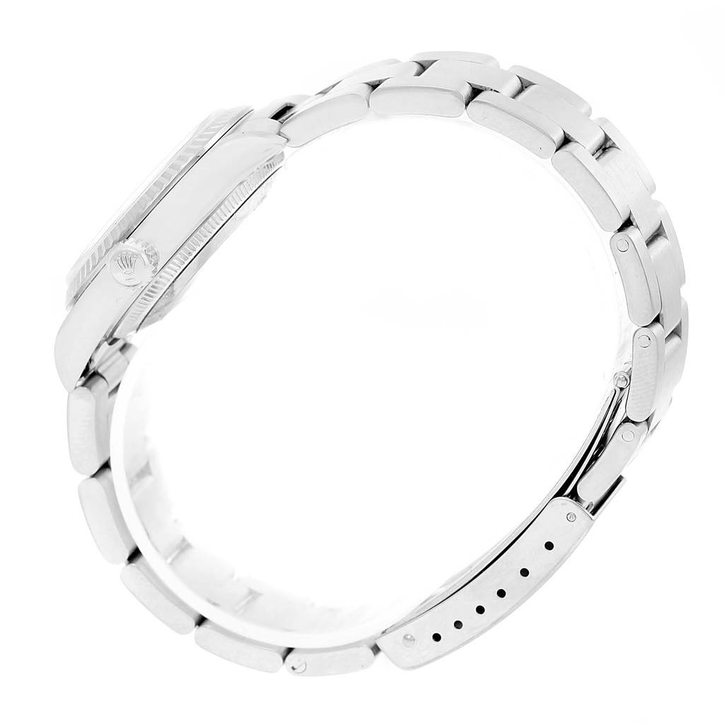 This image shows the side view of a Rolex Mid-Size 77014 Women's Stainless Steel Silver Dial 77014 Women's Stainless Steel Silver Dial model watch, featuring the case and part of the bracelet.