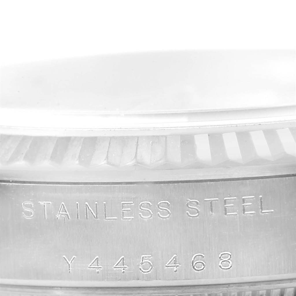 This image shows a close-up angle of the serial number and stainless steel engraving on the side of a Rolex Mid-Size 77014 Women's Stainless Steel Silver Dial 77014 Women's Stainless Steel Silver Dial watch.