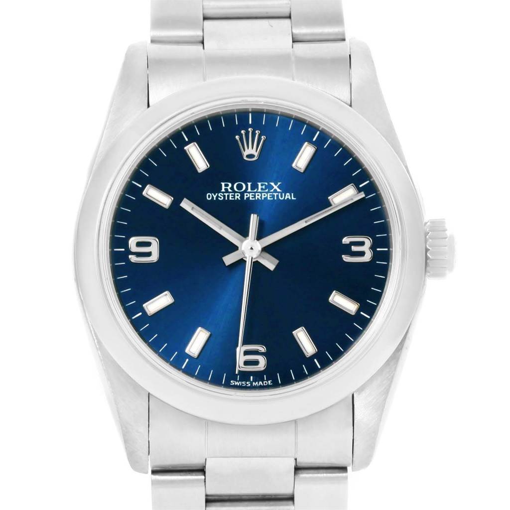 The image shows a front view of a Rolex Mid-Size 77080 Women's Stainless Steel Blue Dial 77080 Women's Stainless Steel Blue Dial Oyster Perpetual watch with a blue dial and silver bracelet.