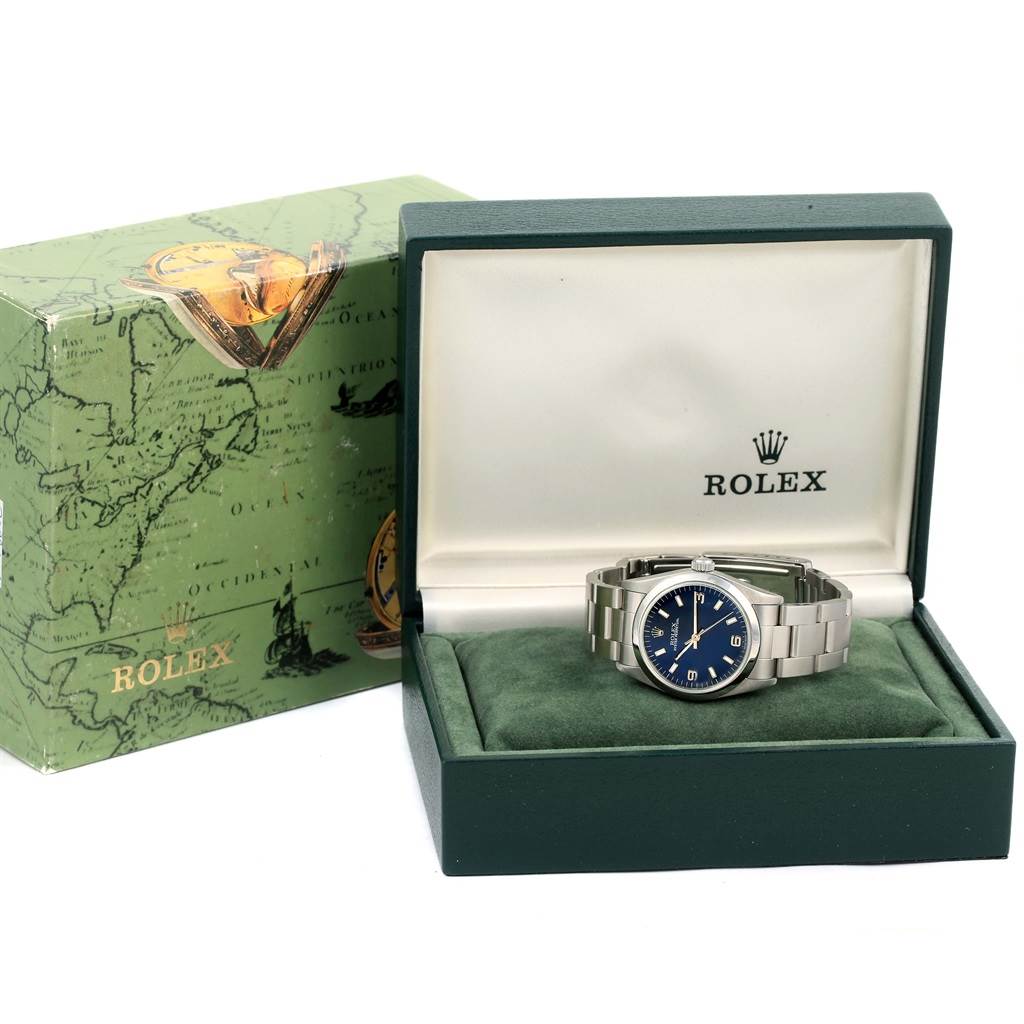 The image shows a Mid-Size Rolex watch with a blue dial, displayed in an open Rolex box with the outer box beside it.