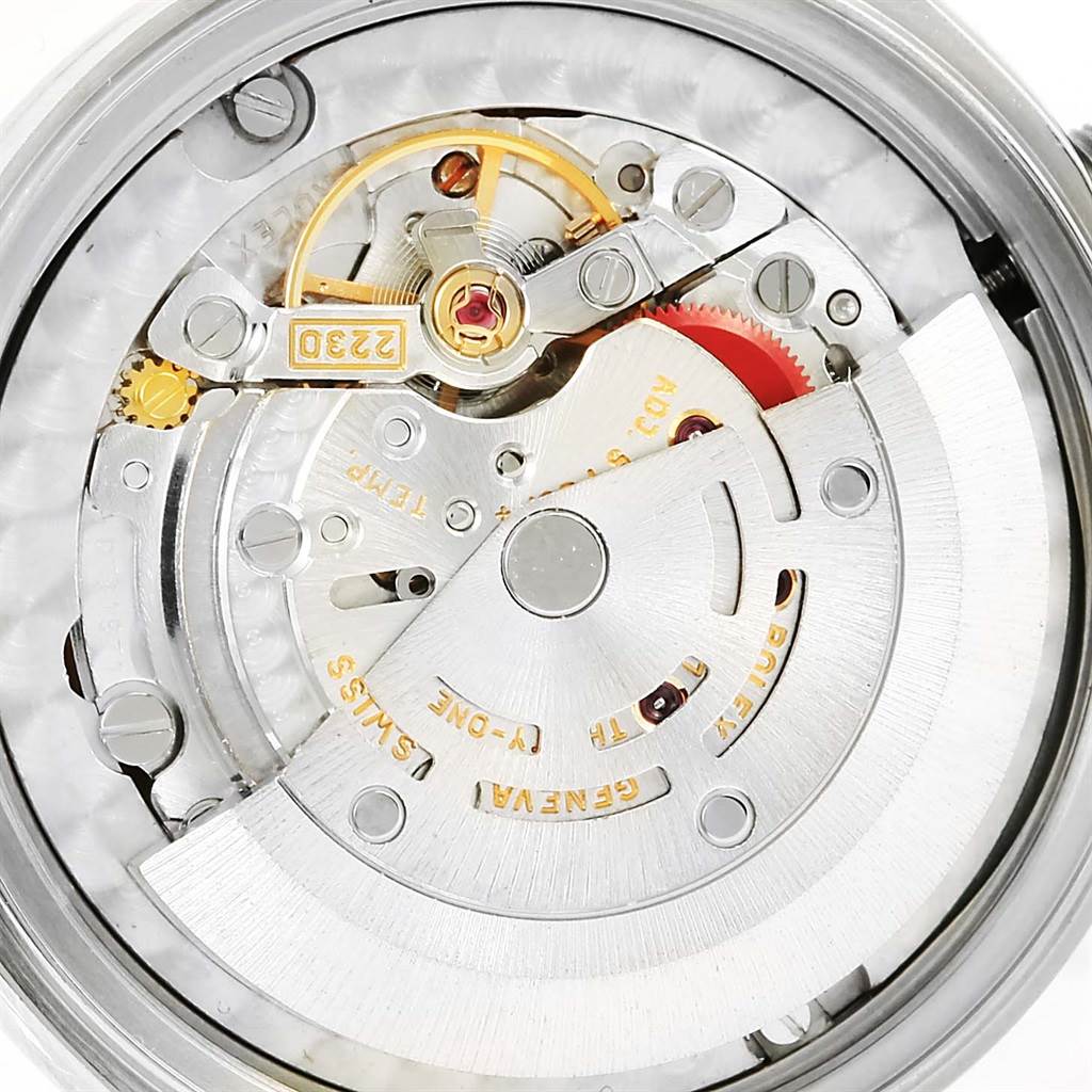 This is a close-up view of the internal mechanism of a Rolex Mid-Size 77080 Women's Stainless Steel Blue Dial 77080 Women's Stainless Steel Blue Dial model watch, showing gears and the rotor.