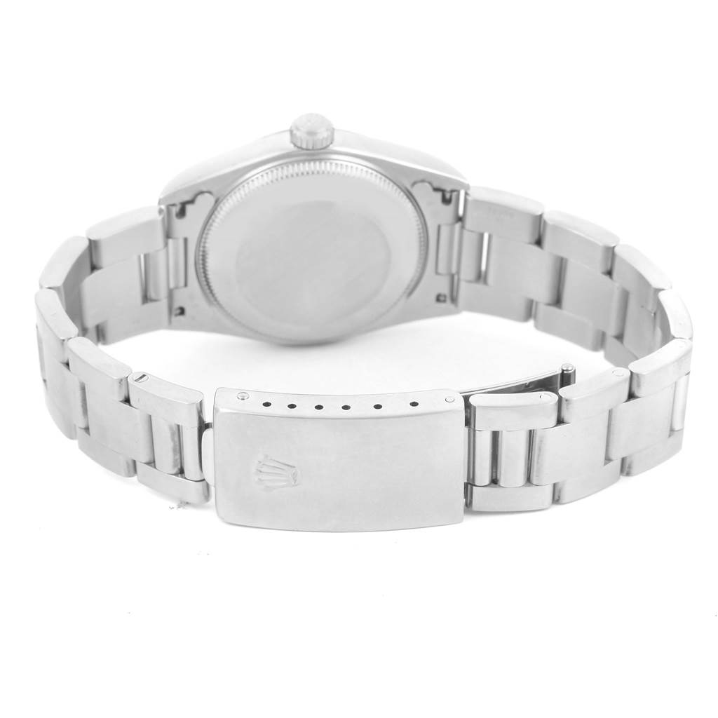 This image shows the back view of a Rolex Mid-Size 77080 Women's Stainless Steel Blue Dial 77080 Women's Stainless Steel Blue Dial watch, highlighting the case back, crown, and bracelet with the clasp.