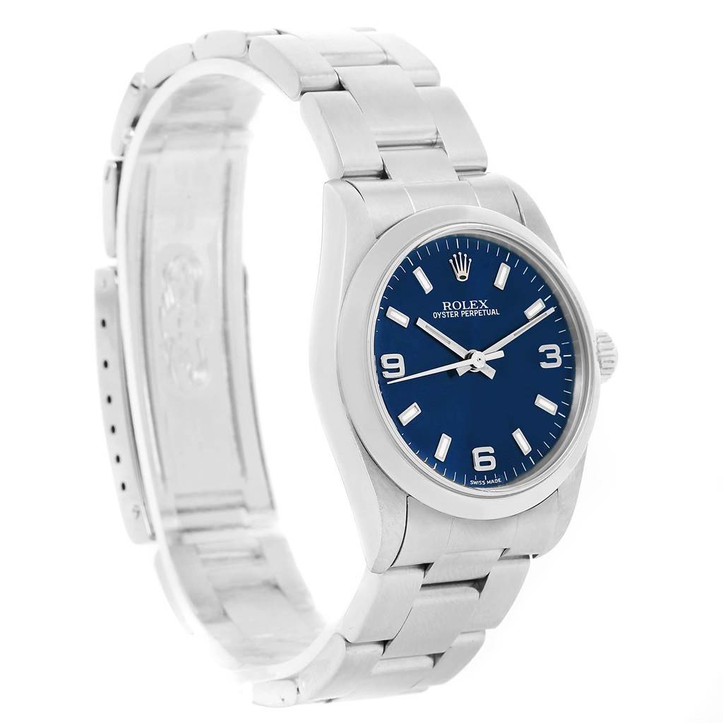 The Rolex Mid-Size 77080 Women's Stainless Steel Blue Dial 77080 Women's Stainless Steel Blue Dial watch is shown at an angle displaying its face, bezel, and partially open stainless steel bracelet.