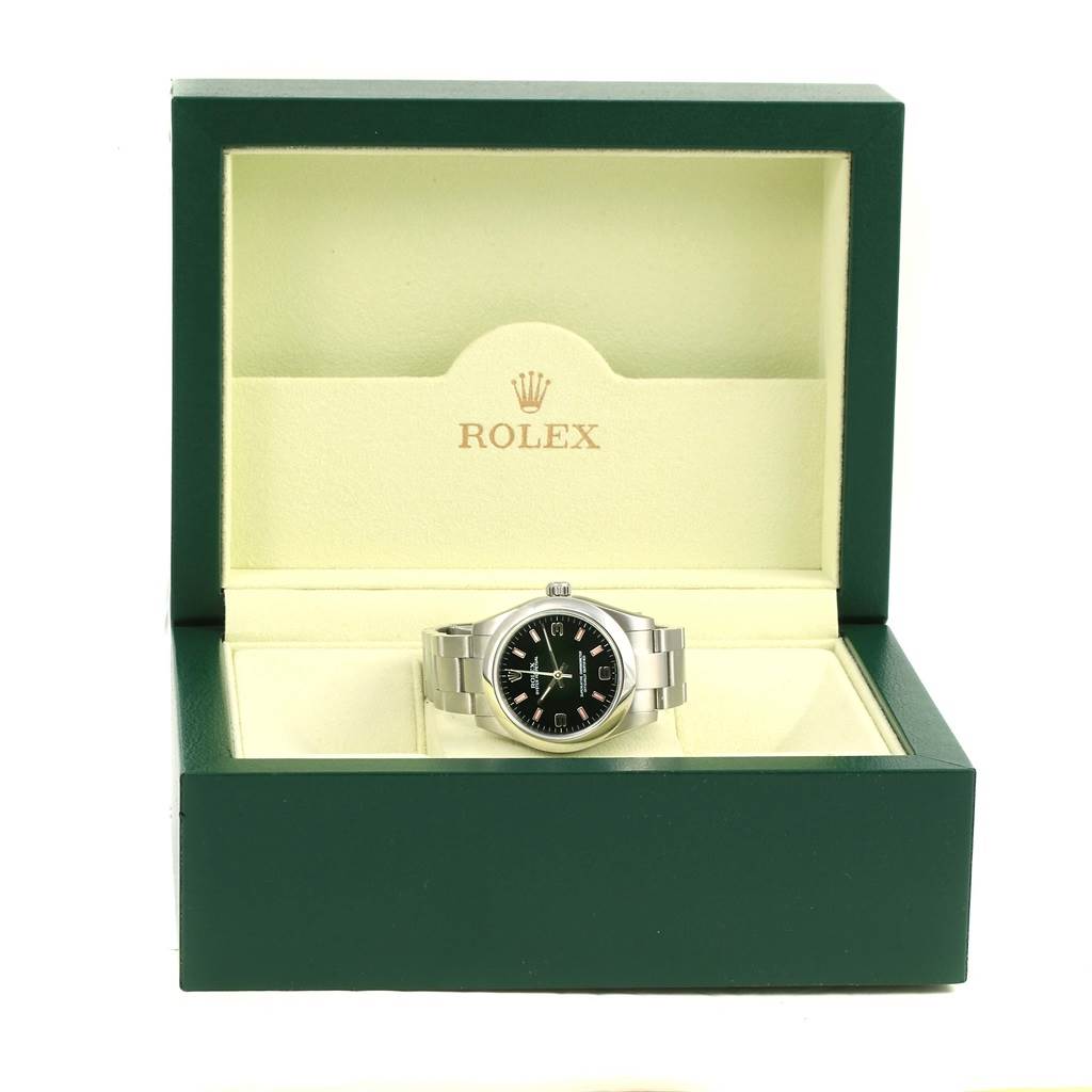 The Mid-Size Rolex watch is shown in an open green Rolex box, displaying the front view of the watch.