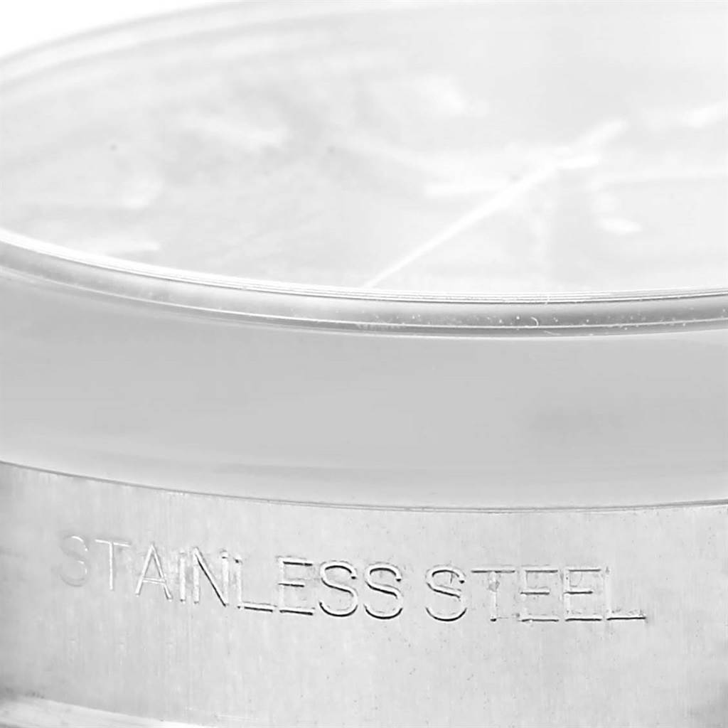 The image shows a close-up of the side of a Mid-Size Rolex watch, highlighting the "Stainless Steel" engraving.