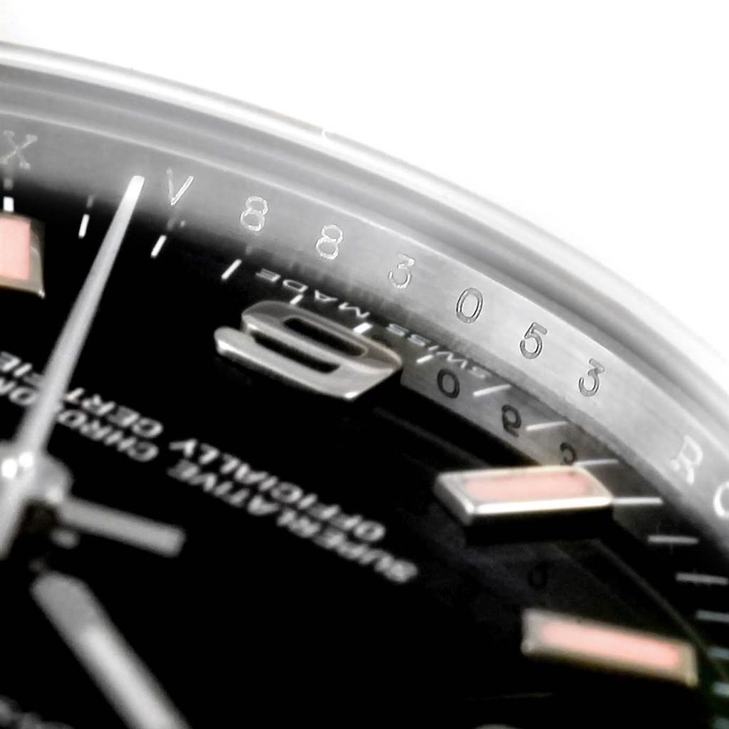 The image shows a close-up of the dial and bezel of a Mid-Size Rolex watch, highlighting the numerals and part of the second hand.