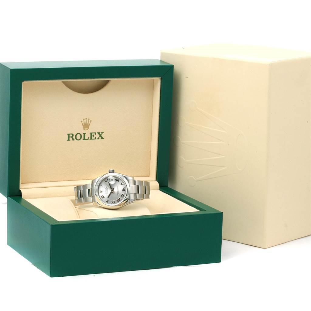 The image shows a Mid-Size Rolex watch placed in its presentation box with the outer packaging partially visible.