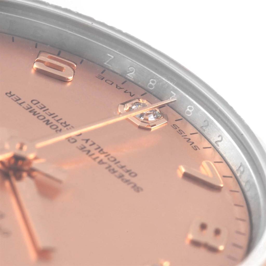The image shows an oblique close-up of the face of a Rolex Mid-Size 178271 Women's Steel and Gold (two tone) Pink Dial 178271 Women's Steel and Gold (two tone) Pink Dial watch, highlighting the hour markers and partially visible text.