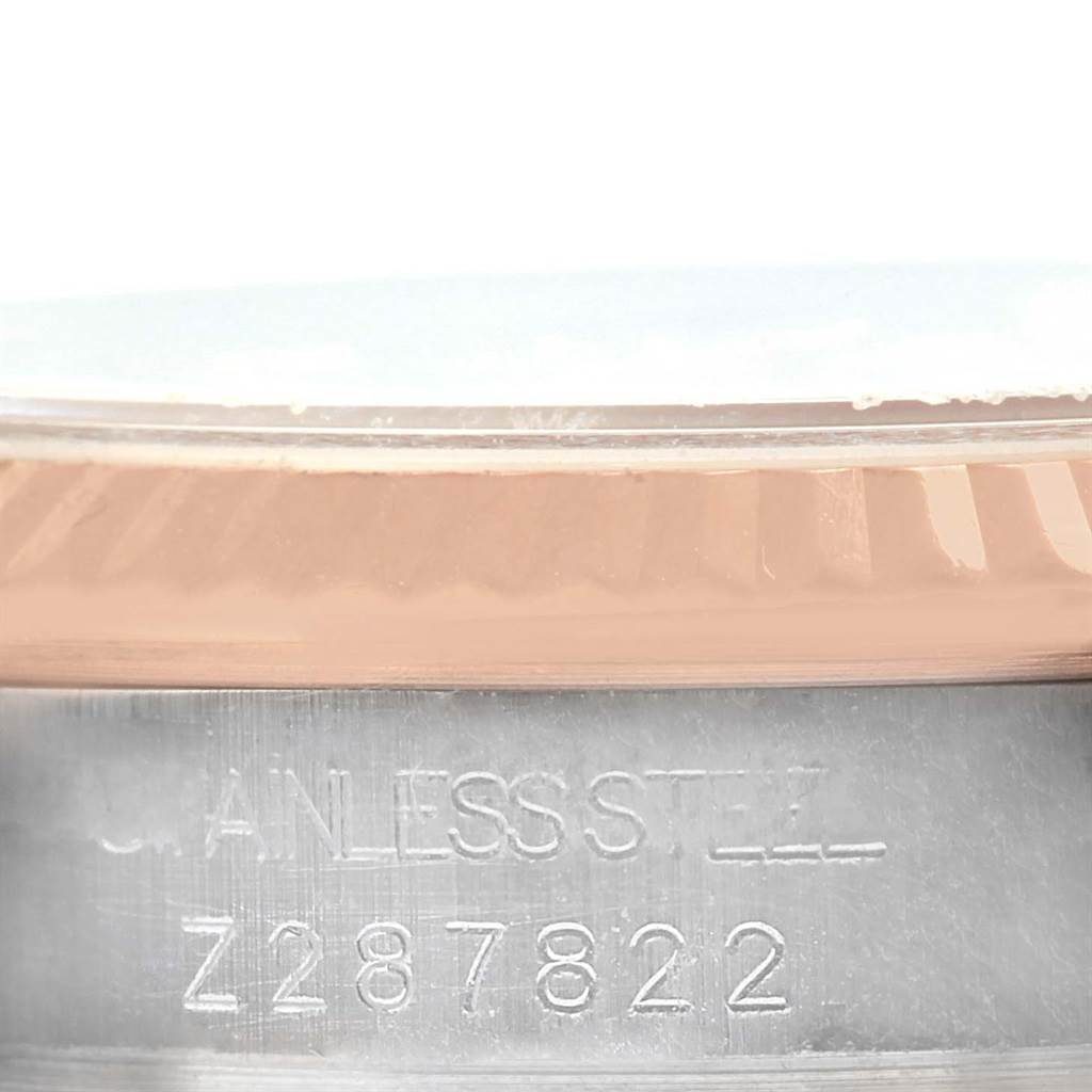 This close-up image shows the side of a Rolex Mid-Size 178271 Women's Steel and Gold (two tone) Pink Dial 178271 Women's Steel and Gold (two tone) Pink Dial watch, highlighting the stainless steel band and engraved model number.