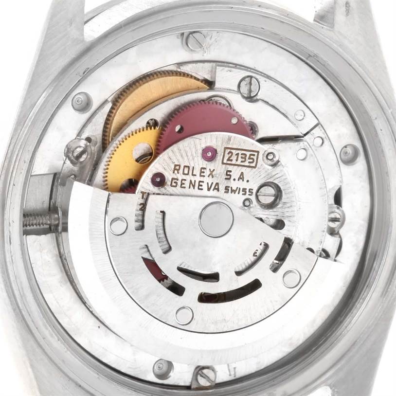 This image shows the inner mechanical movement of a Mid-Size Rolex watch, viewed from the back with the case opened.