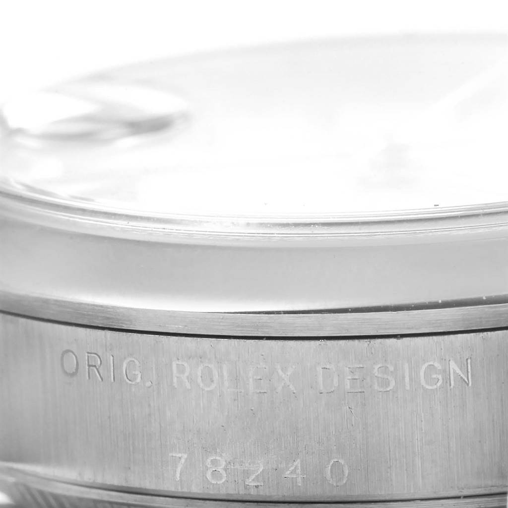 The image shows a close-up of the side of a Rolex Mid-Size 78240 Women's Stainless Steel Silver Dial 78240 Women's Stainless Steel Silver Dial model watch, highlighting the bezel and engraved text.