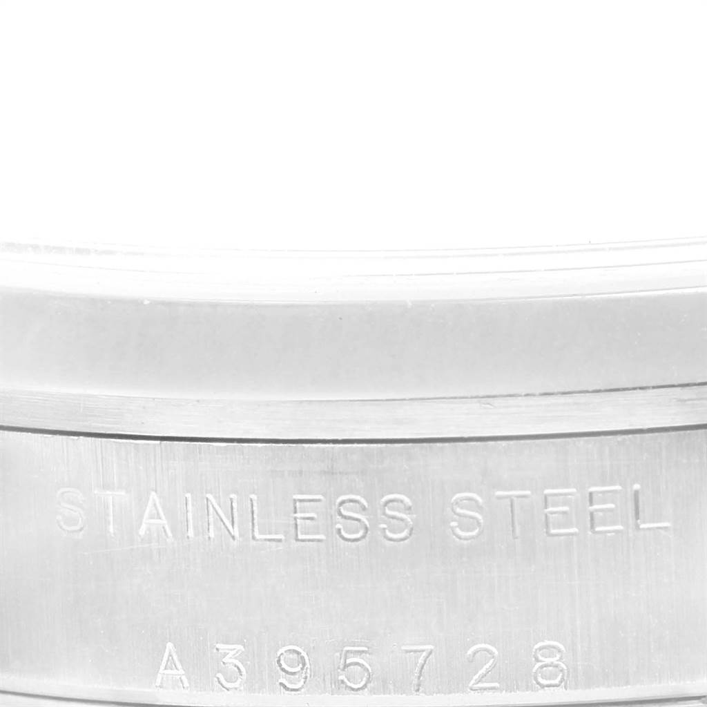 This image shows a close-up of the side of a mid-size Rolex watch case, focusing on the engraved text and serial number. 