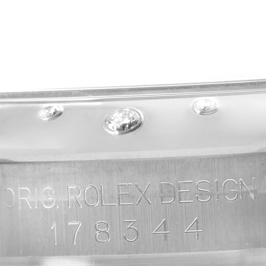 The image shows a close-up of the model number and detailing with diamonds on a Mid-Size Rolex watch.