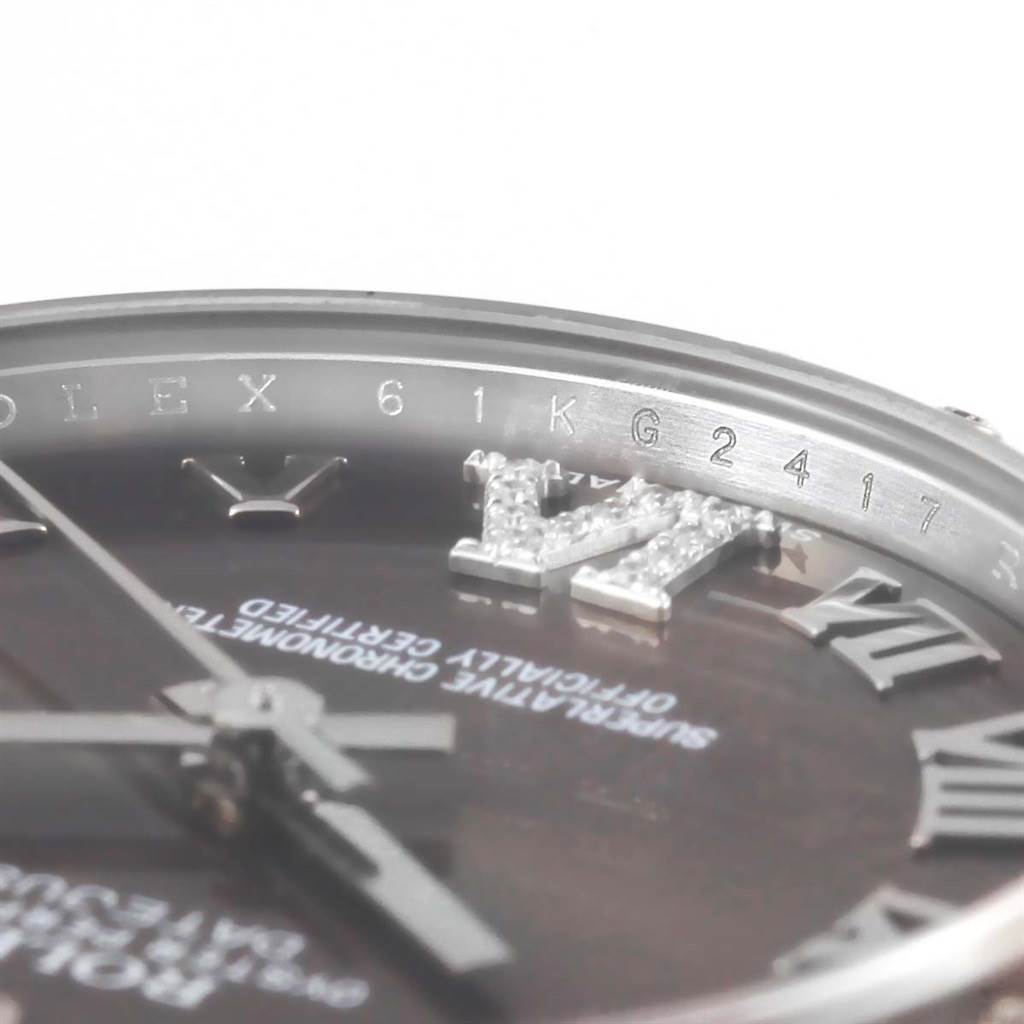 This close-up image shows the partial face and bezel inscription of a Mid-Size Rolex watch, highlighting its intricate details.