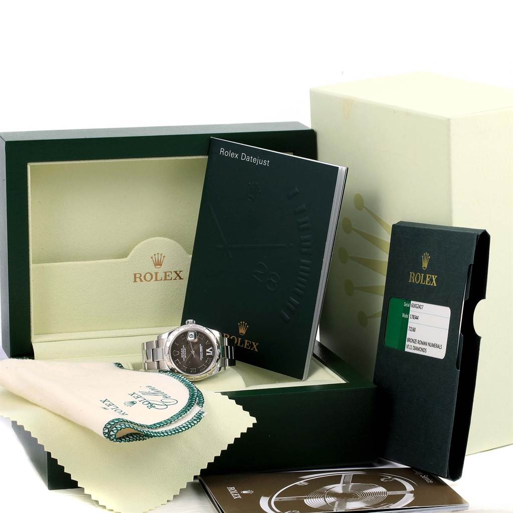 This image features a top-angle view of a Rolex Mid-Size 178344 Women's Stainless Steel Brown Dial 178344 Women's Stainless Steel Brown Dial watch with its box, manuals, and cleaning cloth.