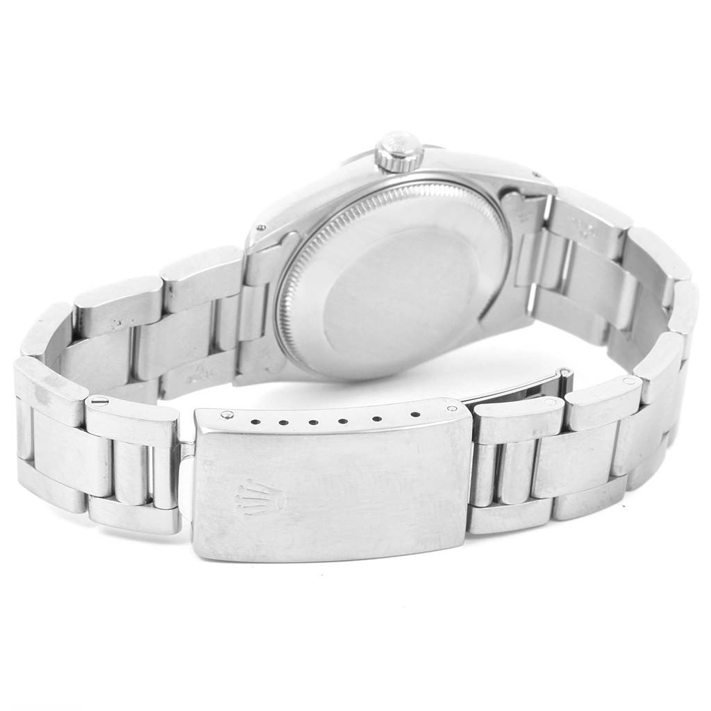 The image shows the back view of the Rolex Mid-Size 67514 Women's Stainless Steel White Dial 67514 Women's Stainless Steel White Dial model watch, focusing on the clasp and bracelet.