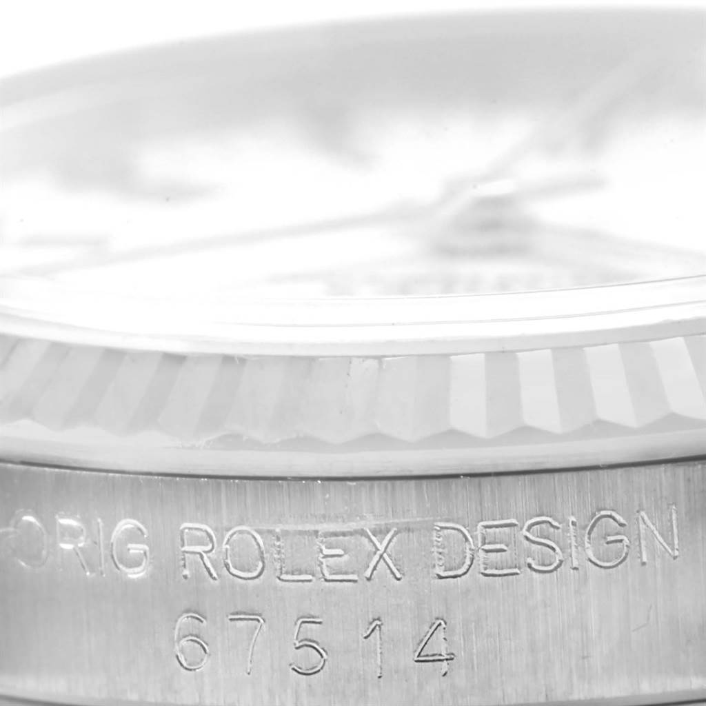 The image shows a close-up side view of a Mid-Size Rolex watch, focusing on the bezel and engraved model number 67514.