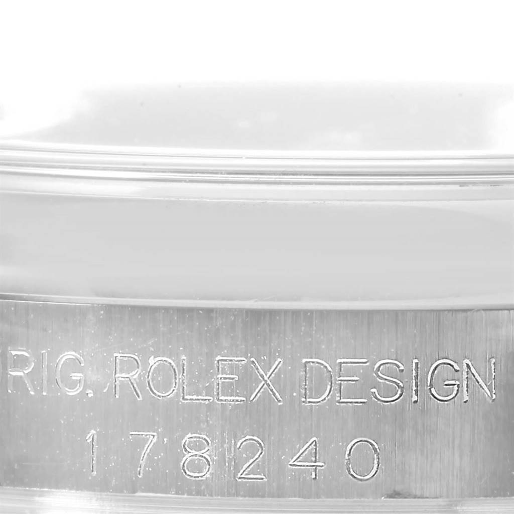 This close-up image shows the serial number engraved on the side of the case of a Mid-Size Rolex watch, model 178240.