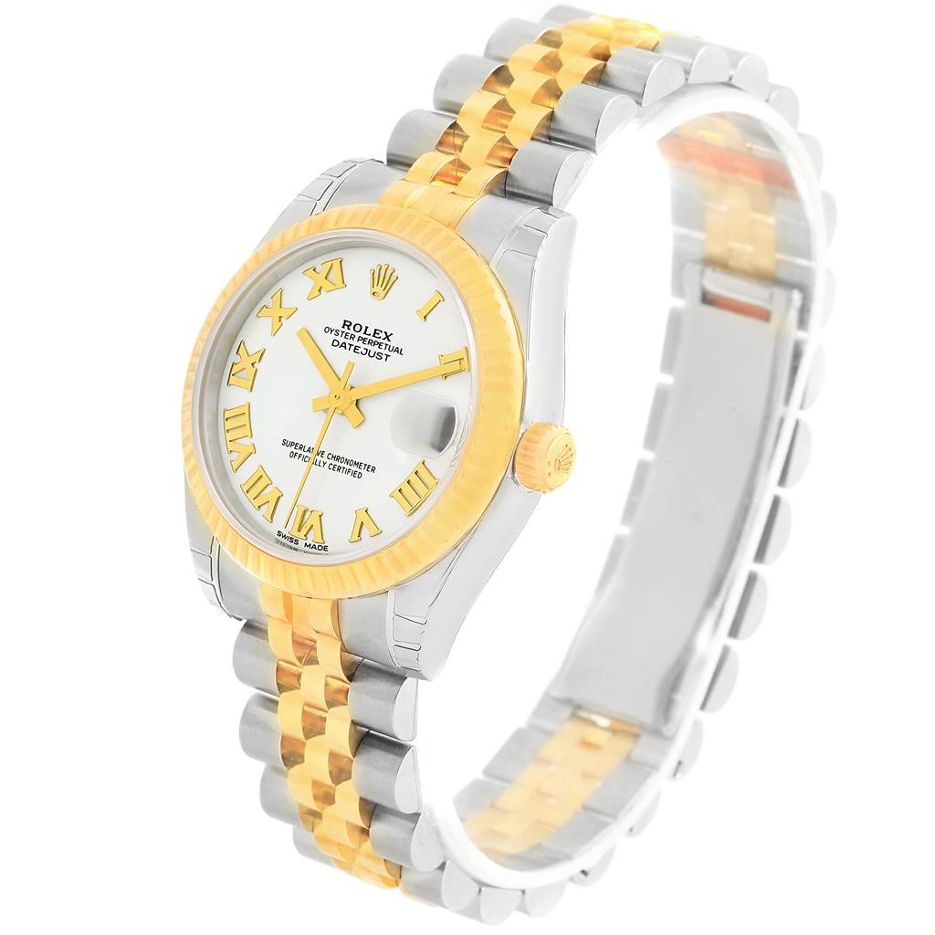 The Mid-Size Rolex watch is photographed at an oblique angle, showing the dial, bezel, crown, and bracelet.