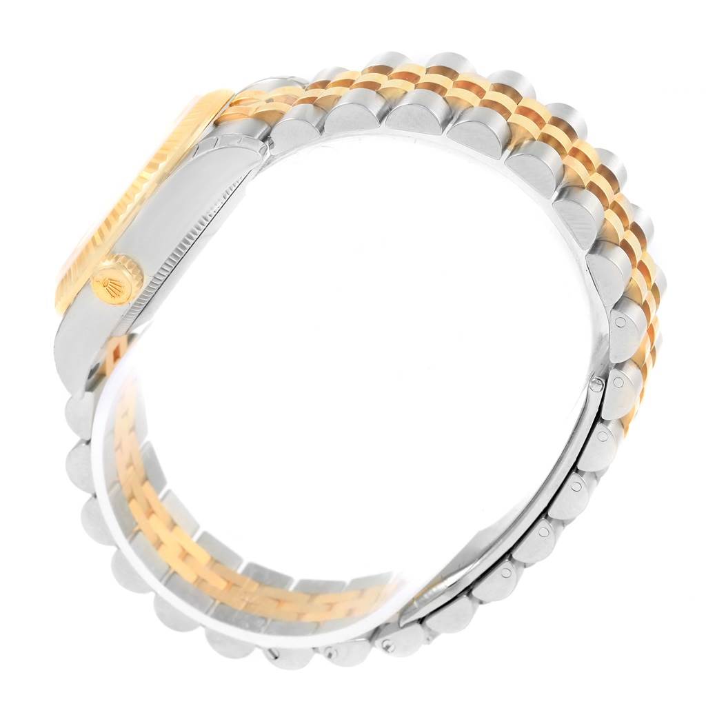 The image shows the side view of a Rolex Mid-Size 178273 Women's Steel and Gold (two tone) White Dial 178273 Women's Steel and Gold (two tone) White Dial model watch, highlighting its two-tone bracelet and crown.