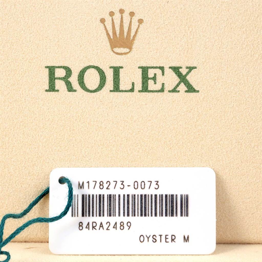 This image shows a tag and box with the model and brand "Mid-Size Rolex Oyster M."