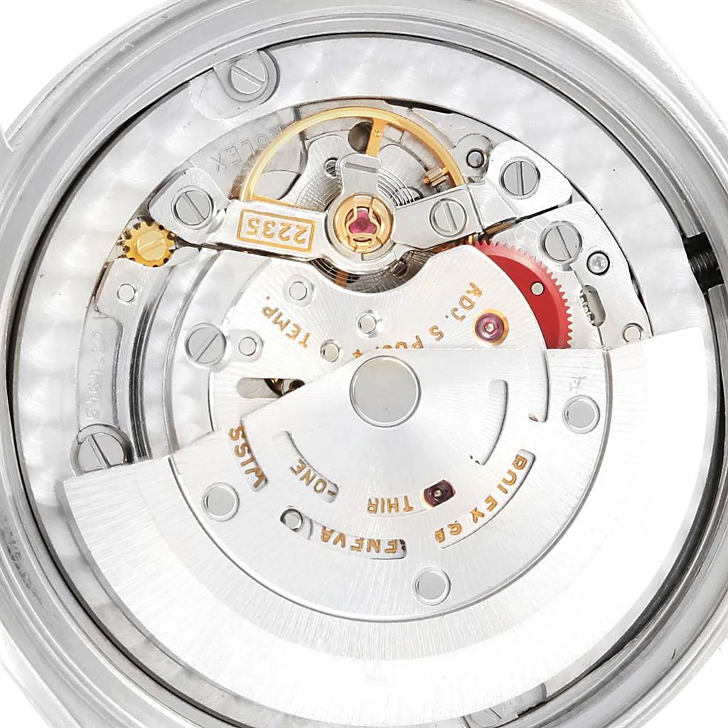 The image shows the internal movement mechanism of a Mid-Size Rolex watch from a close-up, top-down angle.