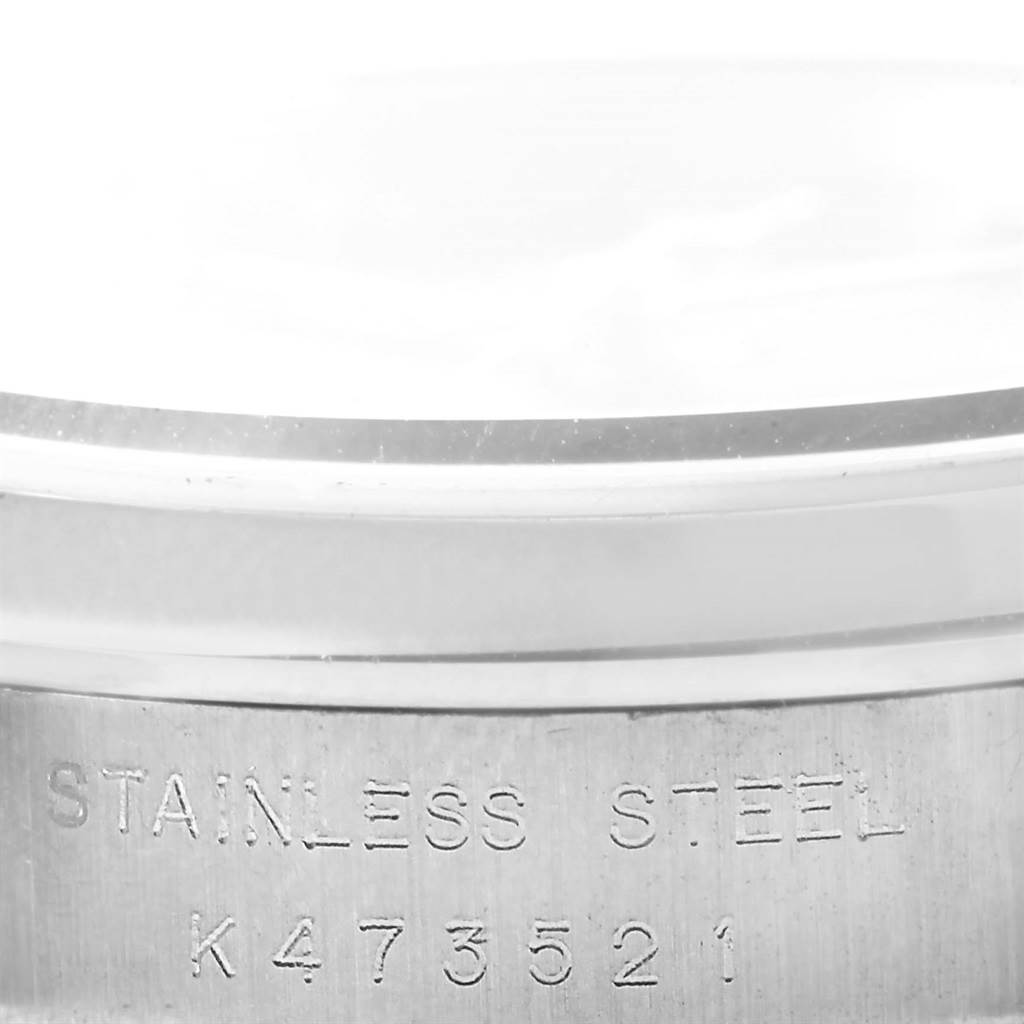 This image shows a close-up of the stainless steel frame with engravings on a Rolex Mid-Size 78240 Women's Stainless Steel Black Dial 78240 Women's Stainless Steel Black Dial model.