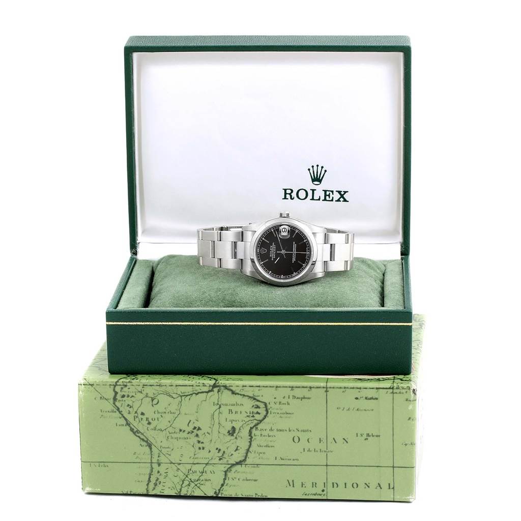 The mid-size Rolex watch is shown inside an open green Rolex box, highlighting the watch face and bracelet.