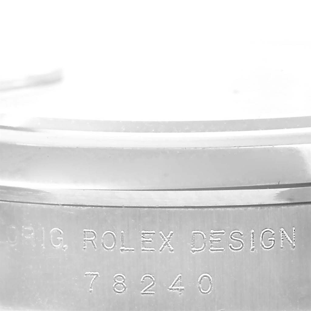 This close-up image shows the side of a Rolex Mid-Size 78240 Women's Stainless Steel Black Dial 78240 Women's Stainless Steel Black Dial watch with the engraving "ORIG ROLEX DESIGN 78240."