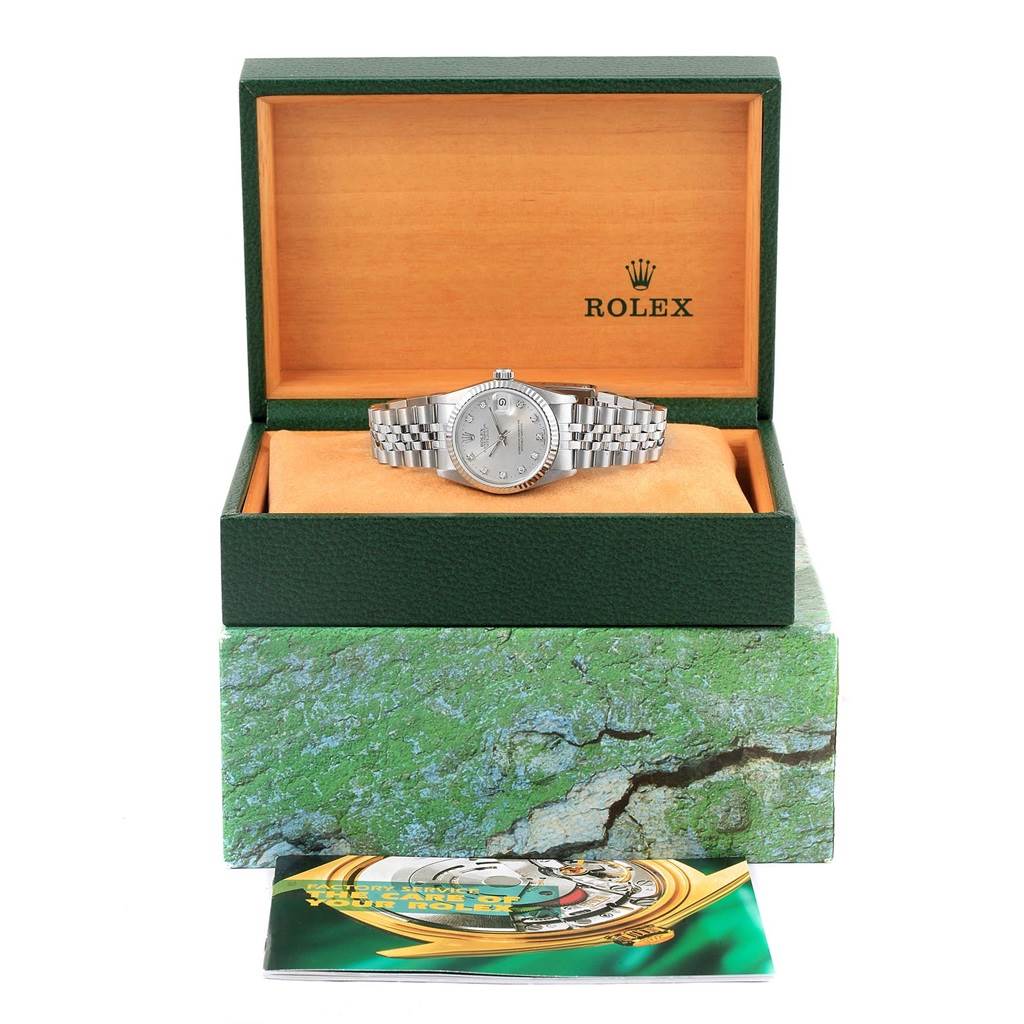 The image shows a Rolex Mid-Size 68274 Women's Stainless Steel Silver Dial 68274 Women's Stainless Steel Silver Dial watch within its open green box, atop a textured box, with a booklet in front.