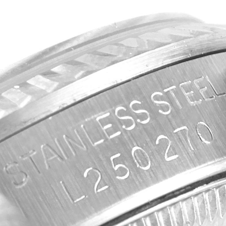 The image shows a close-up angle of the serial number engraved on the stainless steel casing of a Rolex Mid-Size 68274 Women's Stainless Steel Silver Dial 68274 Women's Stainless Steel Silver Dial model watch.