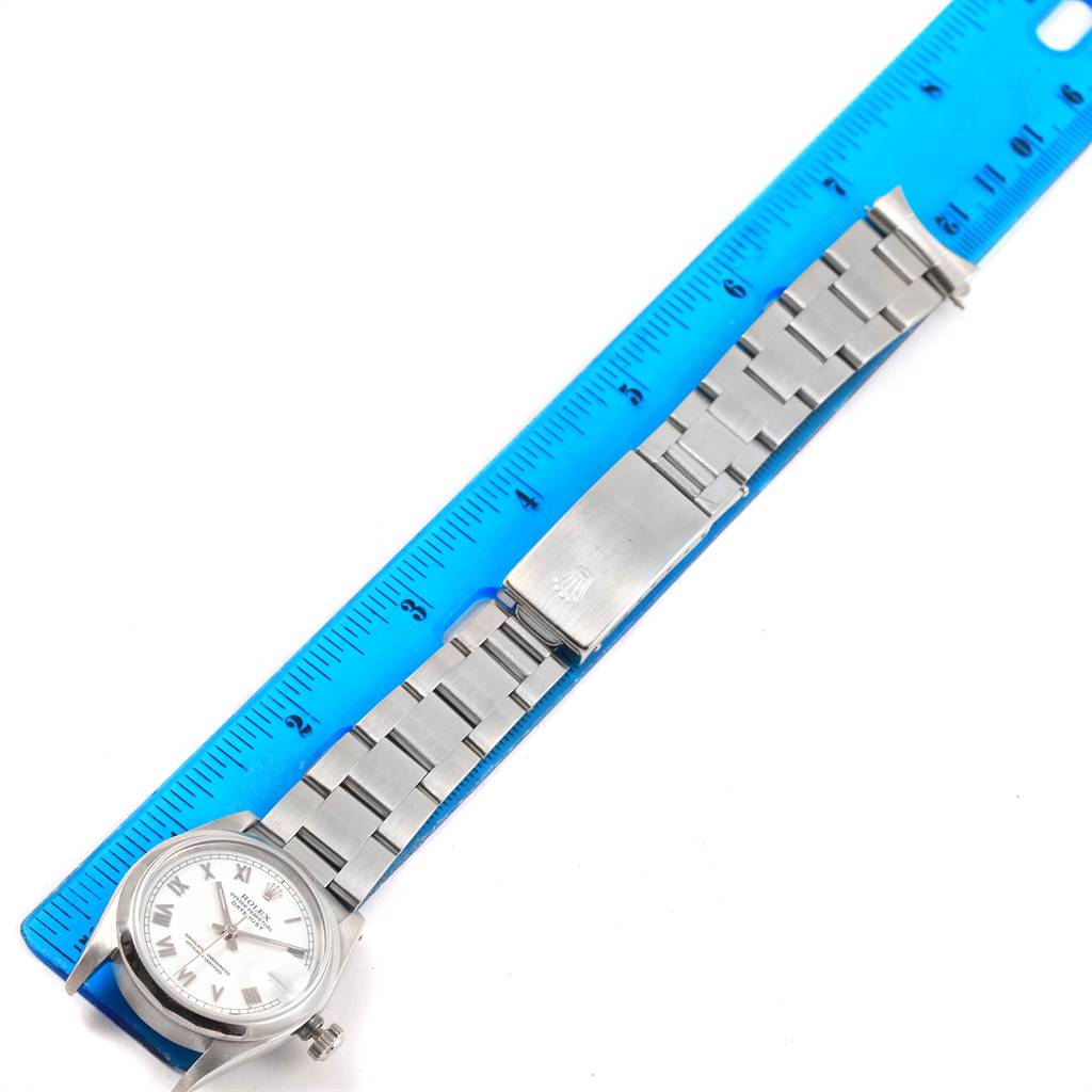 The Rolex Mid-Size 68240 Women's Stainless Steel White Dial 68240 Women's Stainless Steel White Dial watch is shown laid flat with the full length of the band and clasp visible beside a ruler for scale.