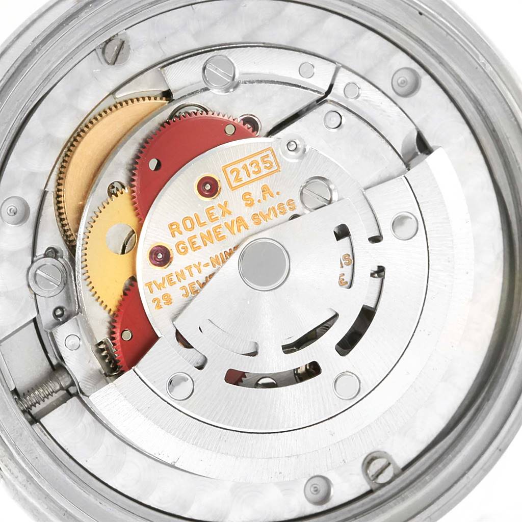 This is an internal view showing the movement mechanism of a Rolex Mid-Size 68240 Women's Stainless Steel White Dial 68240 Women's Stainless Steel White Dial model, featuring gears and the "ROLEX S.A. GENEVA SWISS" engraving.