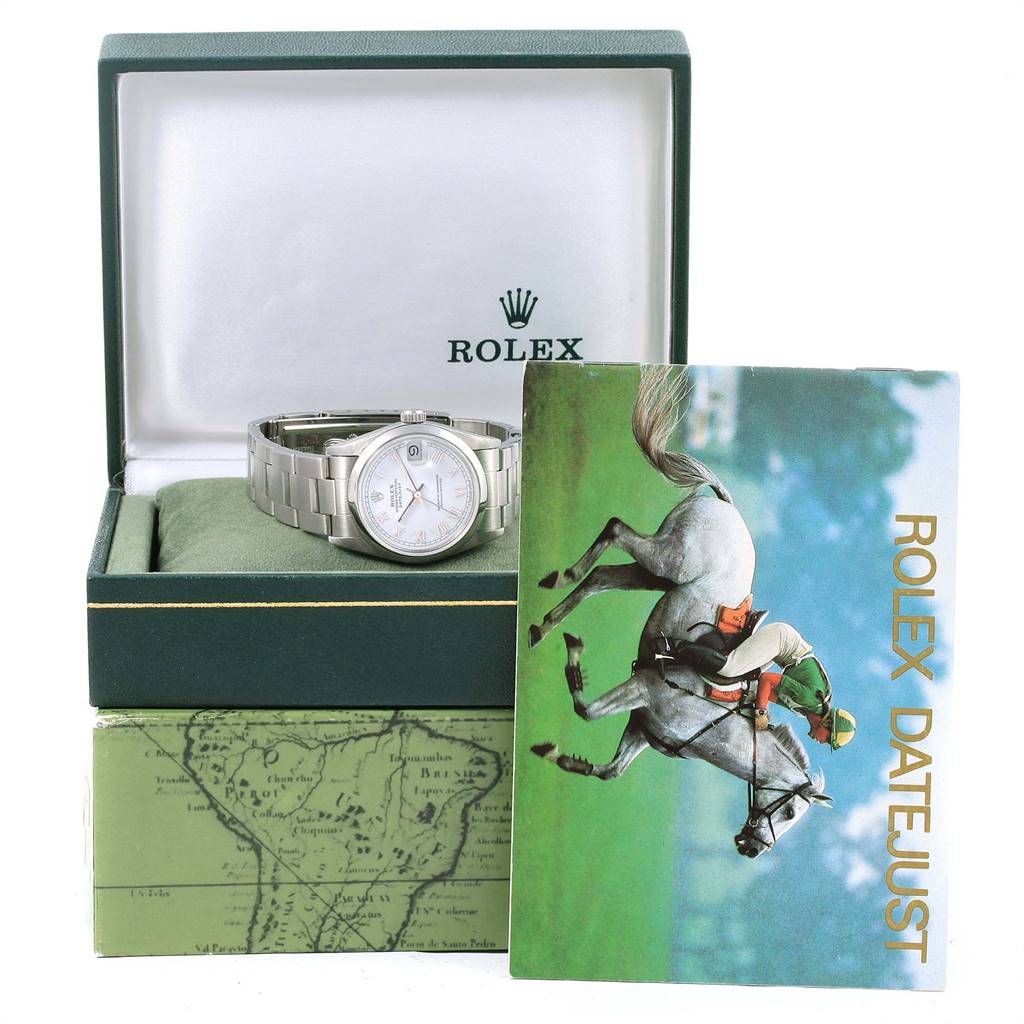 The image shows a mid-size Rolex Datejust watch in an open box with a booklet leaning on it.
