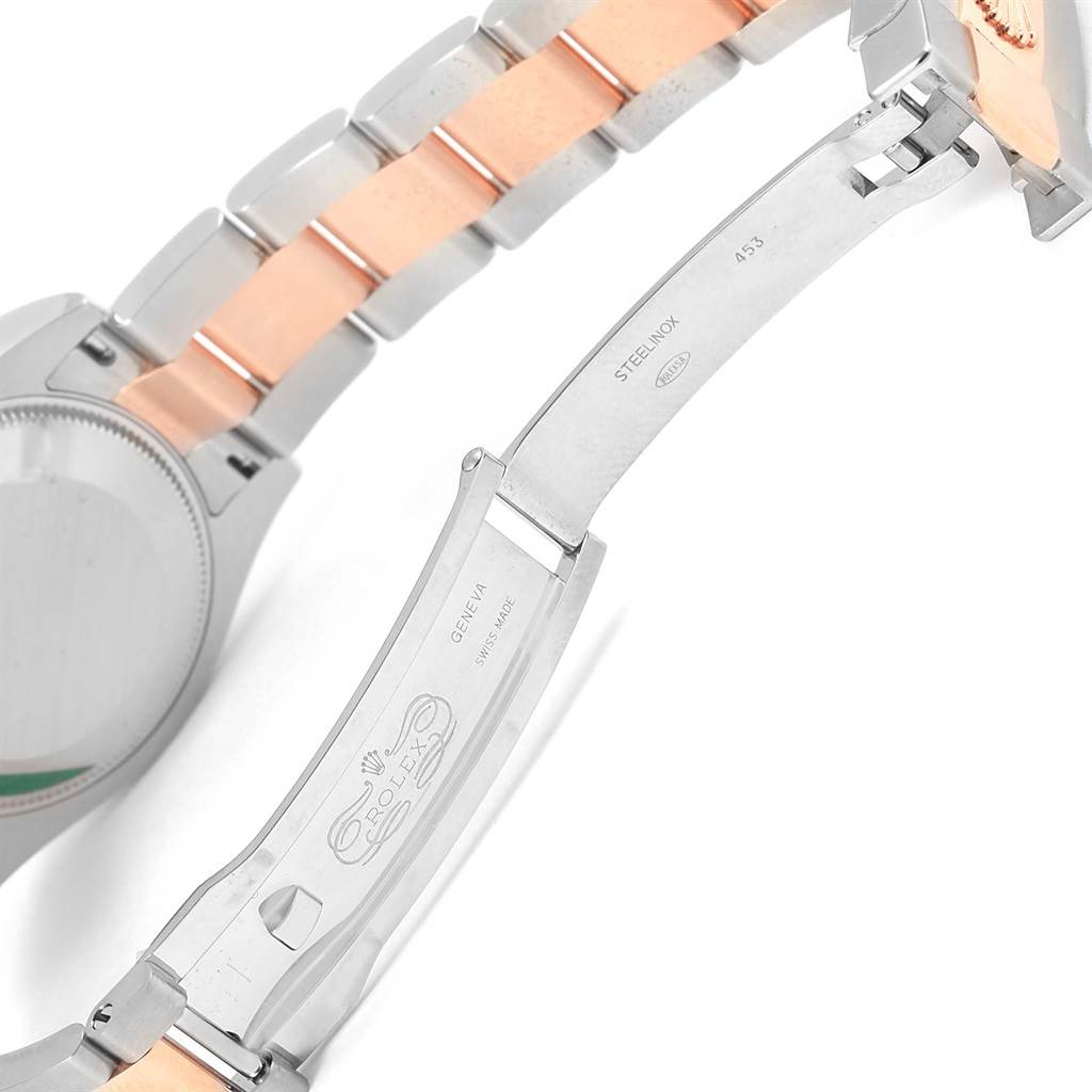 This image shows the open clasp and part of the bracelet of a Mid-Size Rolex watch.