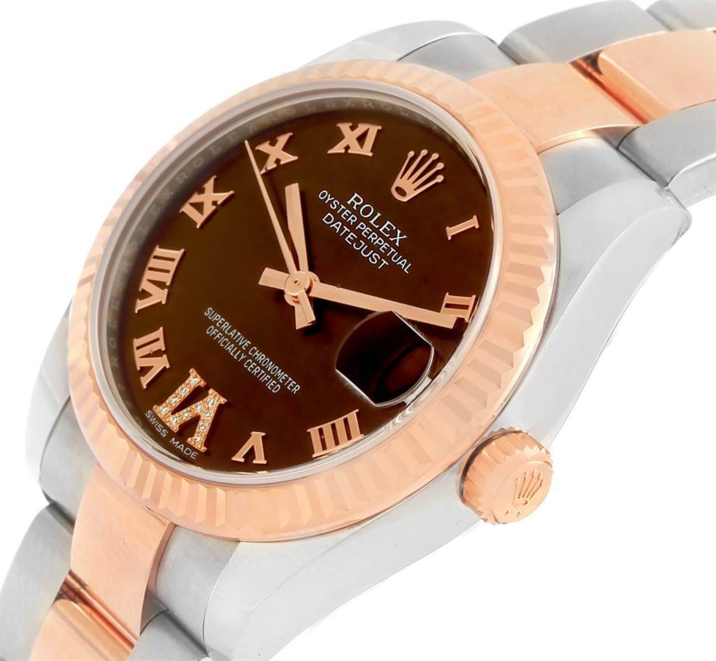 The image shows a close-up angled view of a mid-size Rolex Datejust watch, highlighting the bezel, dial, date window, and part of the bracelet.