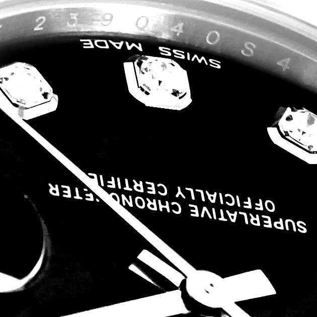 The image shows a close-up of the dial of a Mid-Size Rolex watch, featuring diamond hour markers and partial text.