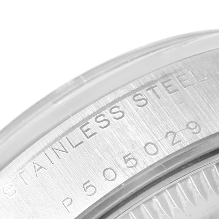 This close-up shows the case back edge of a Mid-Size Rolex watch, displaying the serial number and "STAINLESS STEEL" engraving.