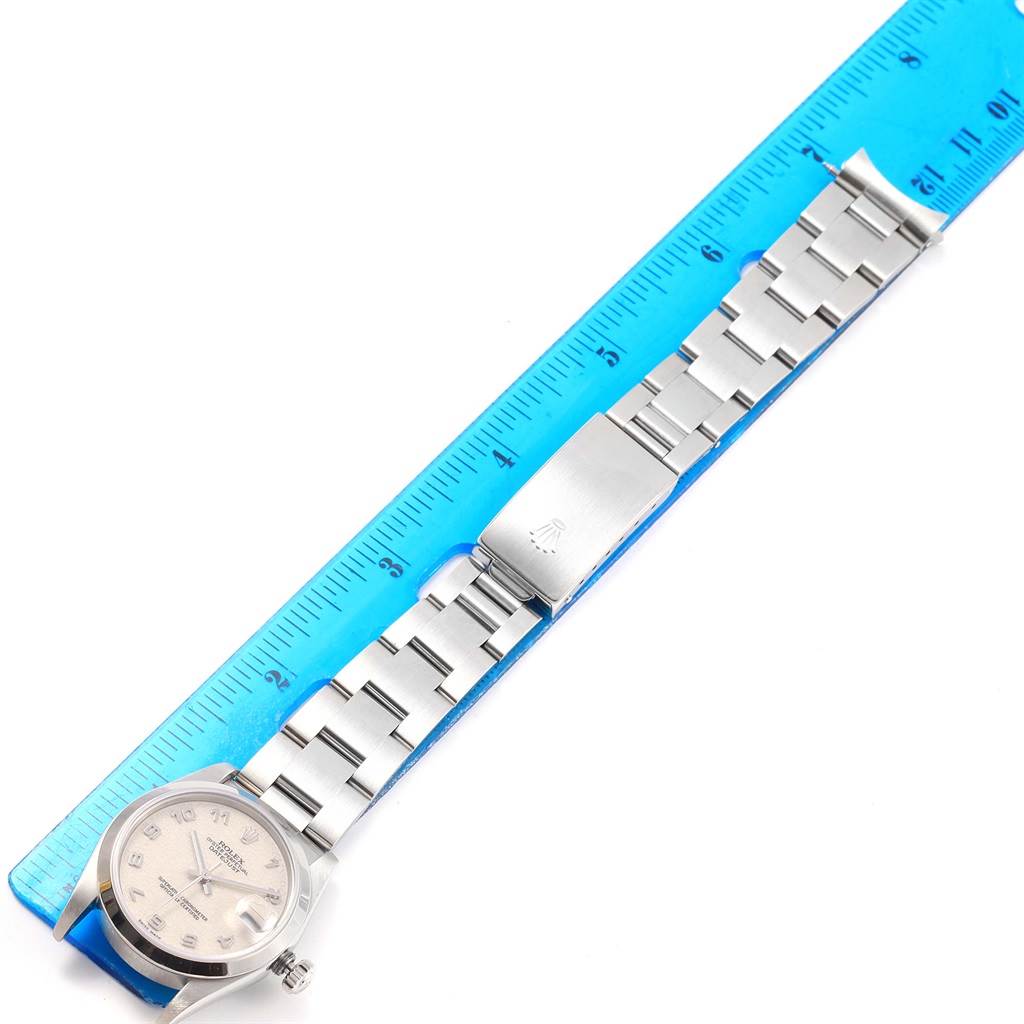 The image shows a Rolex Mid-Size 68240 Women's Stainless Steel Silver Dial 68240 Women's Stainless Steel Silver Dial model watch laying flat next to a blue ruler, highlighting the bracelet, dial, and clasp.