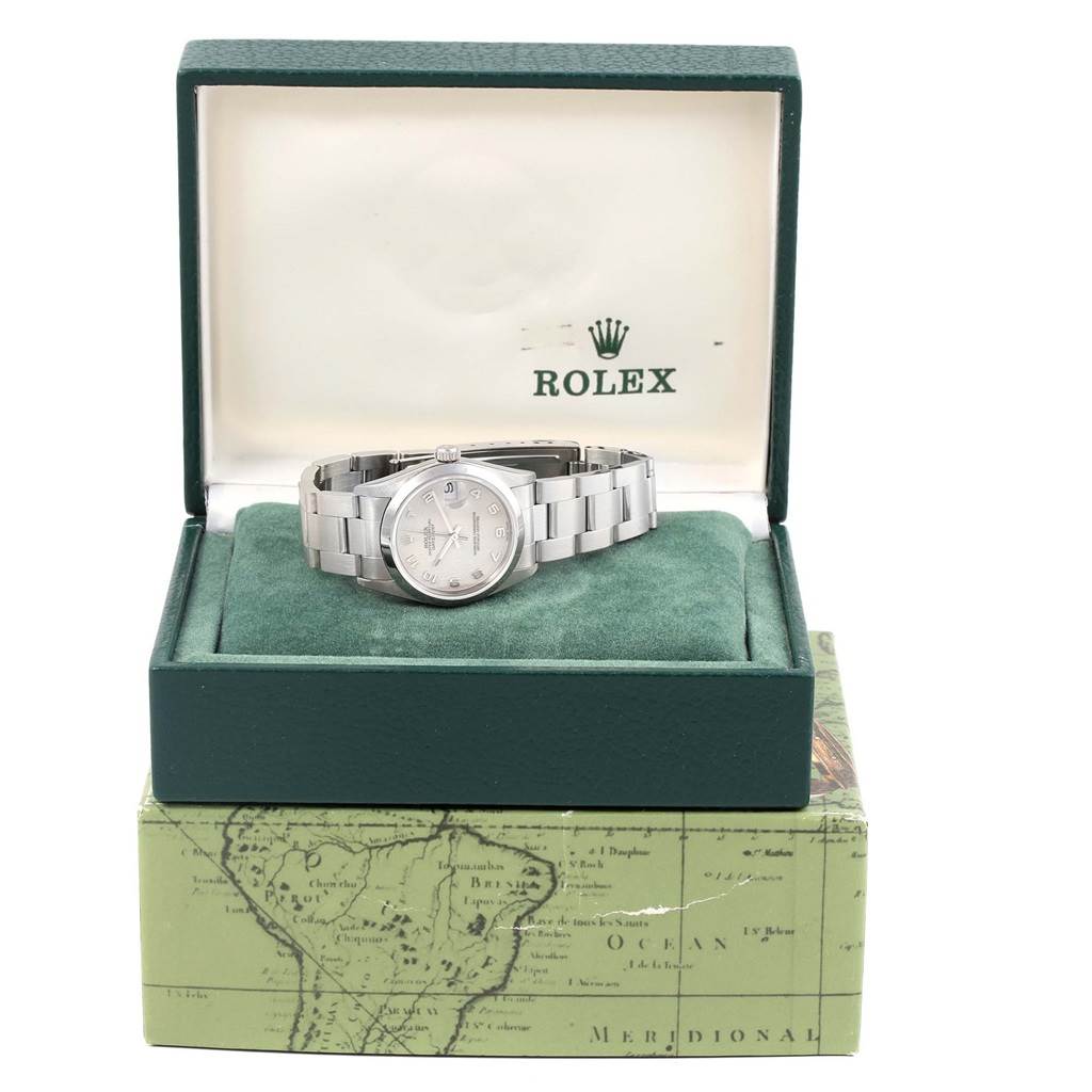 The Rolex Mid-Size 68240 Women's Stainless Steel Silver Dial 68240 Women's Stainless Steel Silver Dial model watch is shown from a front angle, placed in an open green jewelry box.