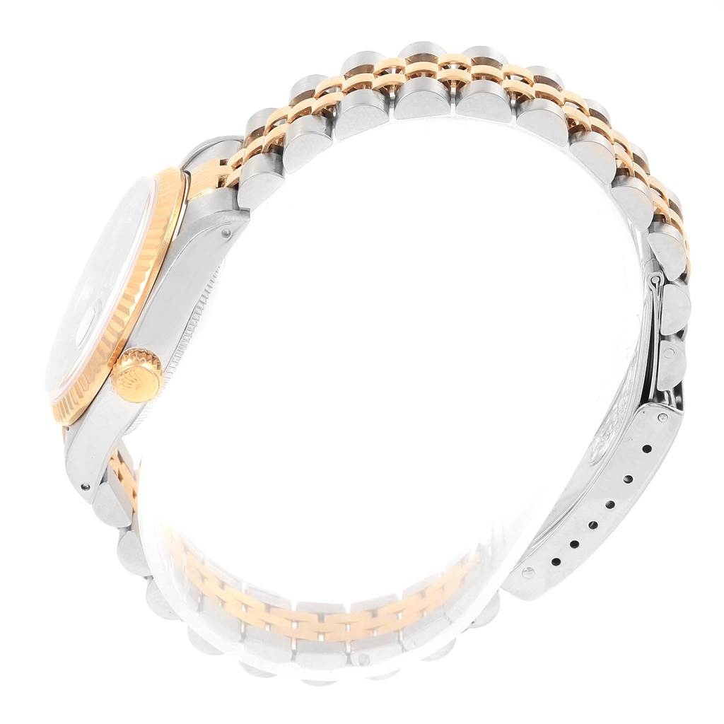 The image shows a side view of a Mid-Size Rolex watch, highlighting the crown, case, and bi-metal bracelet.