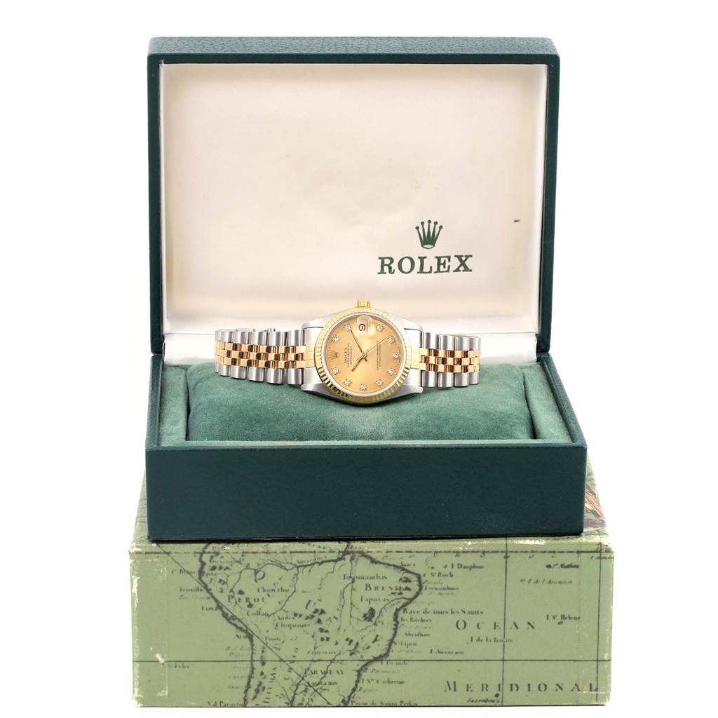 The Rolex Mid-Size 68273 Women's Steel and Gold (two tone) Champagne Dial 68273 Women's Steel and Gold (two tone) Champagne Dial watch is displayed head-on in an open green Rolex box, showing the watch face and two-tone metal bracelet.