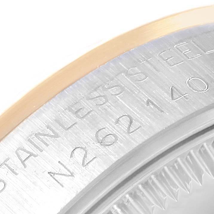 Close-up of the case back of a mid-size Rolex watch, showing part of the serial number and "Stainless Steel" engraving.